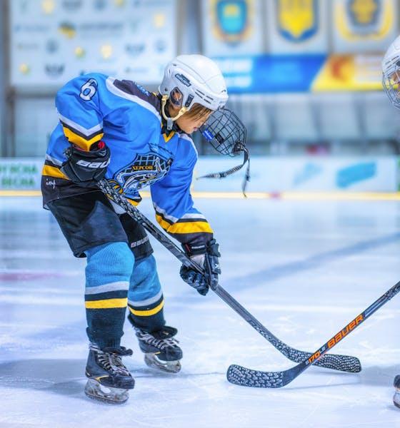 Two people playing ice hockey