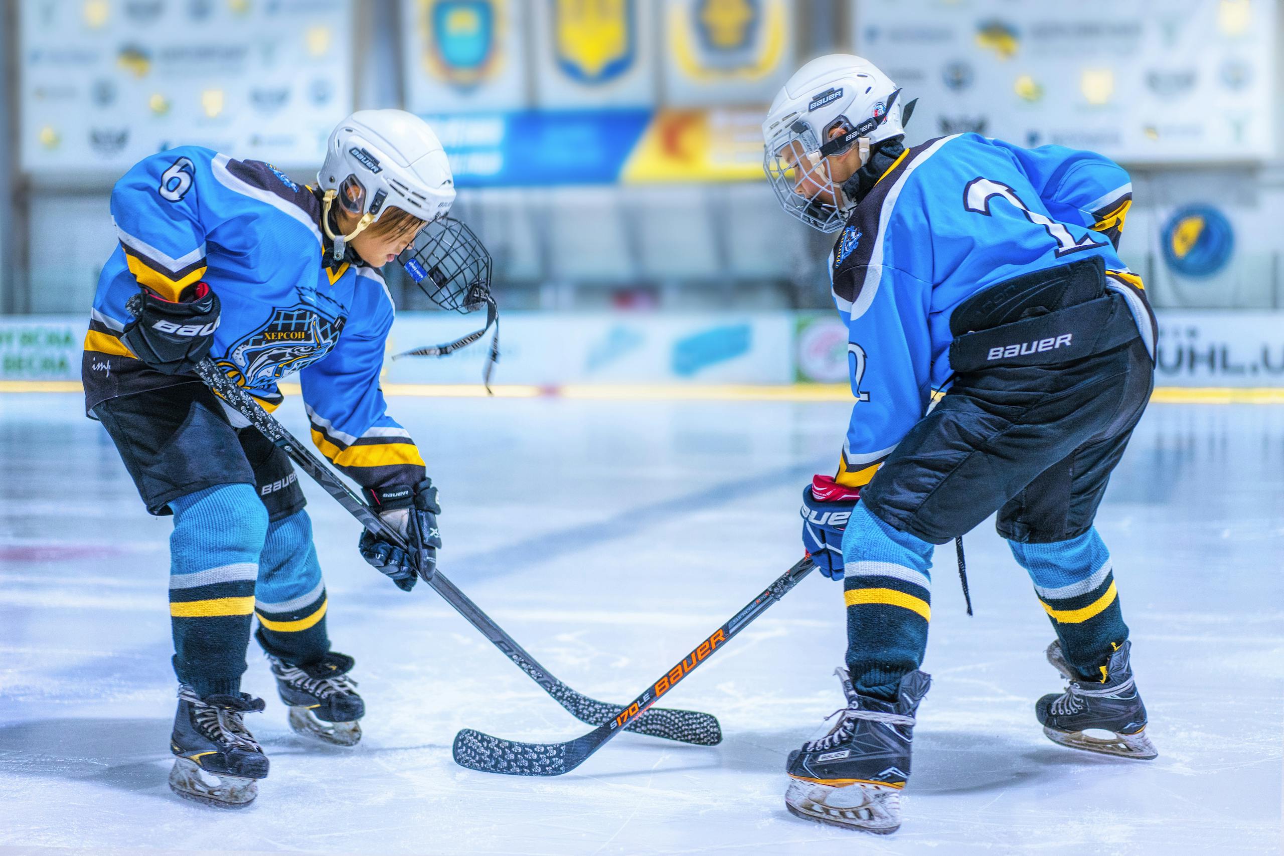 Two people playing ice hockey