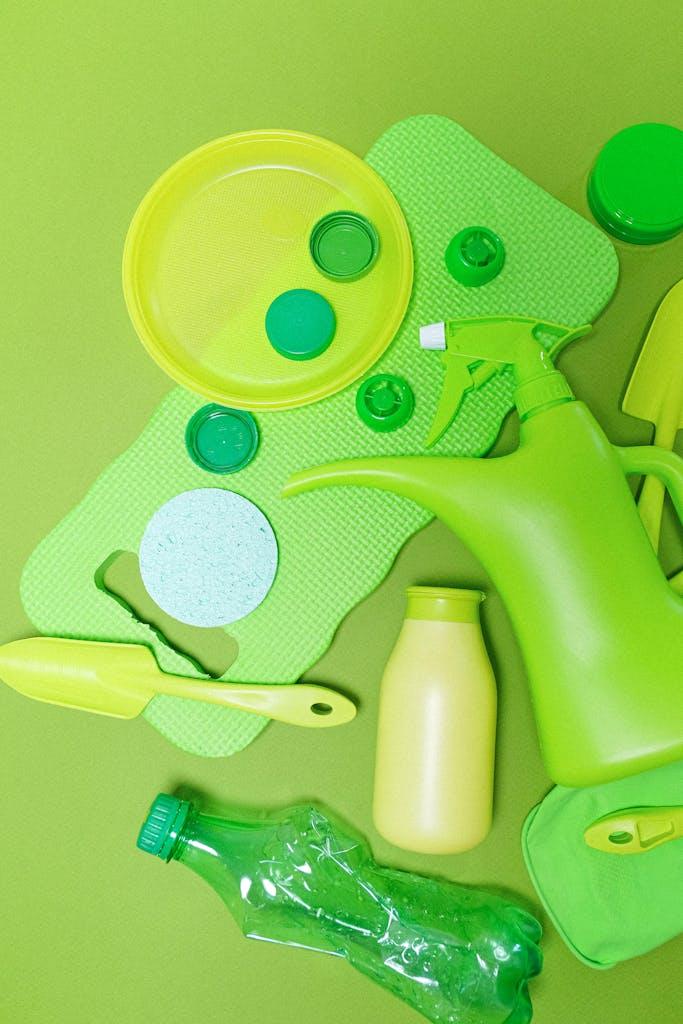 Top view of assorted green plastic kitchen items on a matching background.